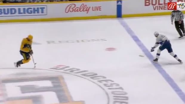 Lightning forward Austin Watson hits Predators defenseman Jeremy Lauzon with a slap shot.